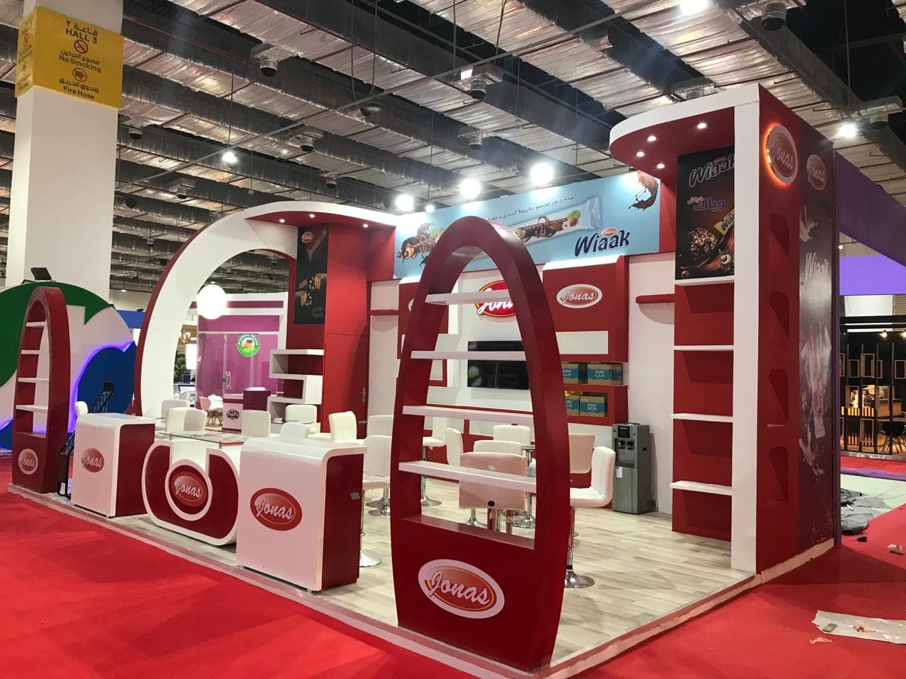 Sculpted arch portal, deep red and cream, Equal's stand for Jonas