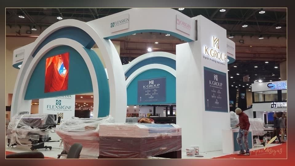 Triple-arch teal portal structure, Equal's stand for K Group