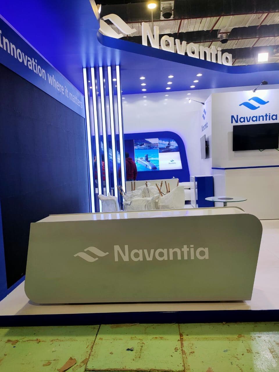 Deep navy and white reception area, Equal's stand for Navantia